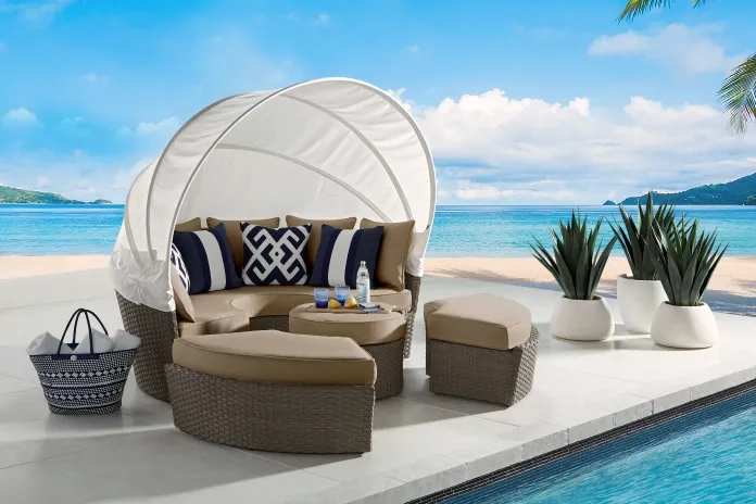 a daybed on a patio near the beach