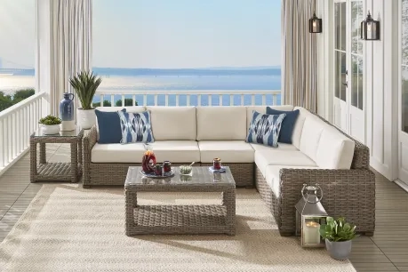 wicker and white L shaped sectional for an outdoor patio 