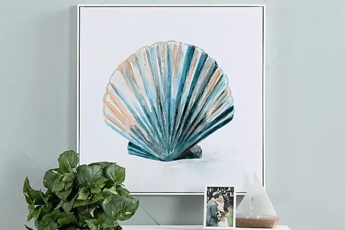 a blue shell art print hanging on white wall