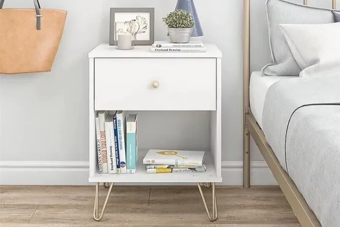white nightstand with a golden knob 