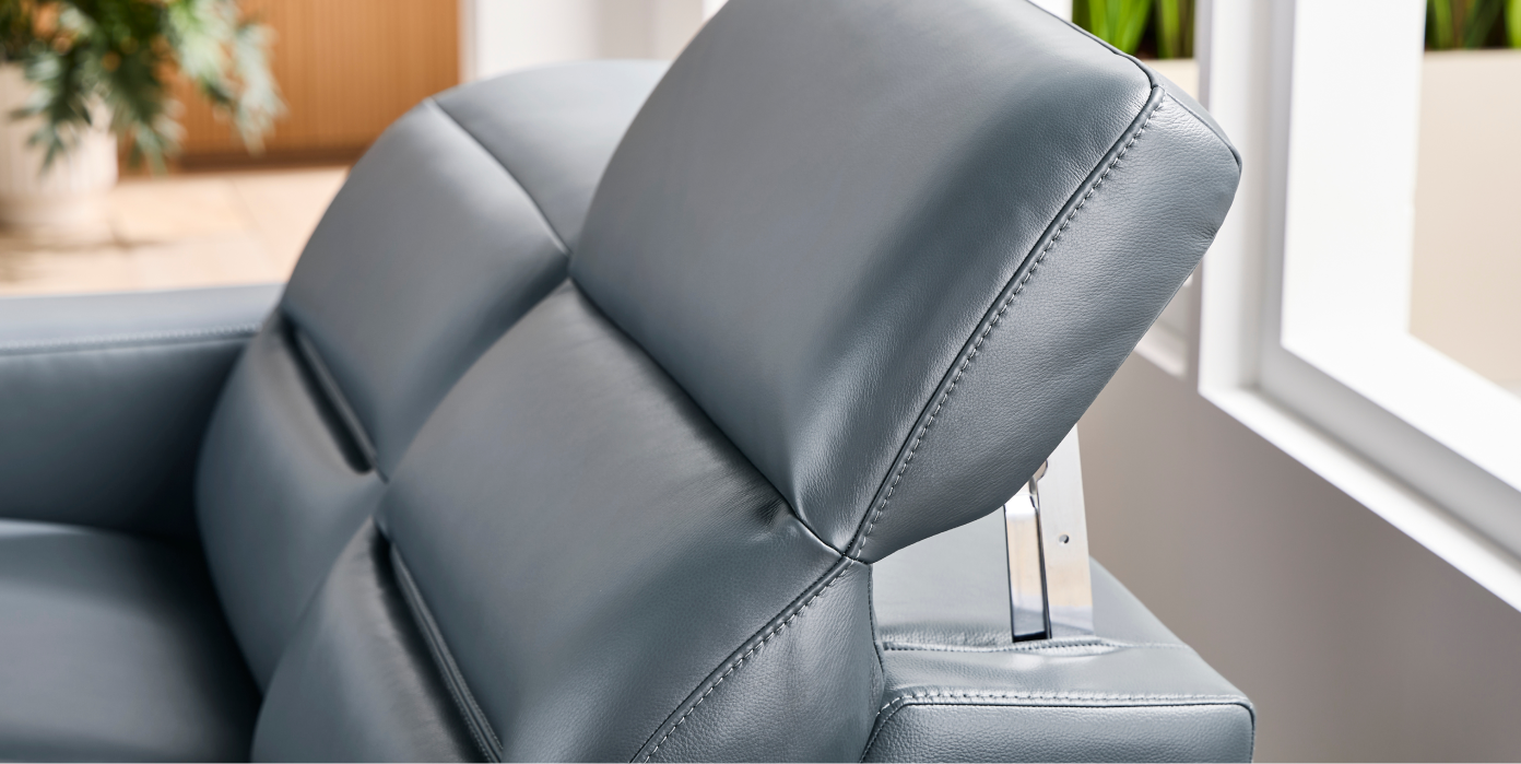 Gray leather sofa with adjustable headrests.
