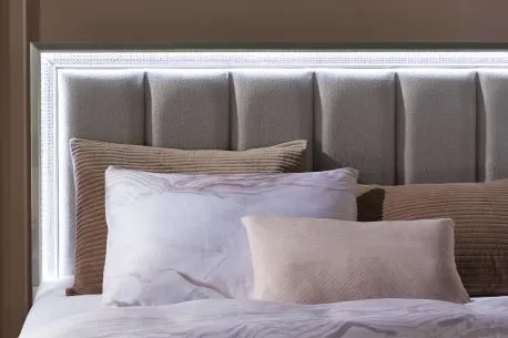 beige bed with high backboard and gray sheets