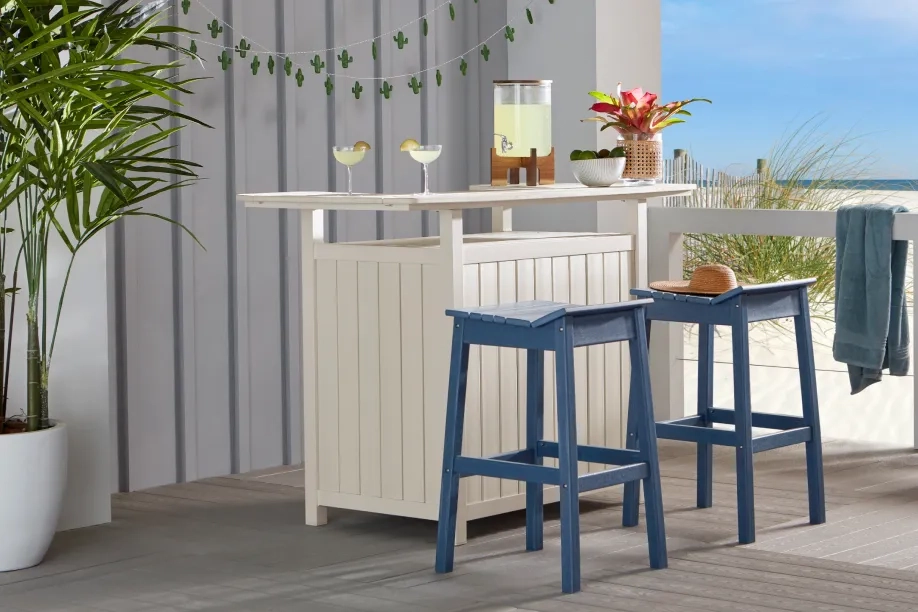 white outdoor bar with blue barstools