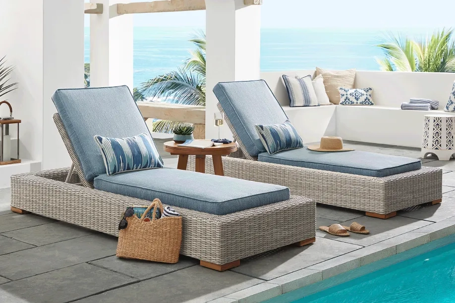 pair of chaise loungers with light blue cushions