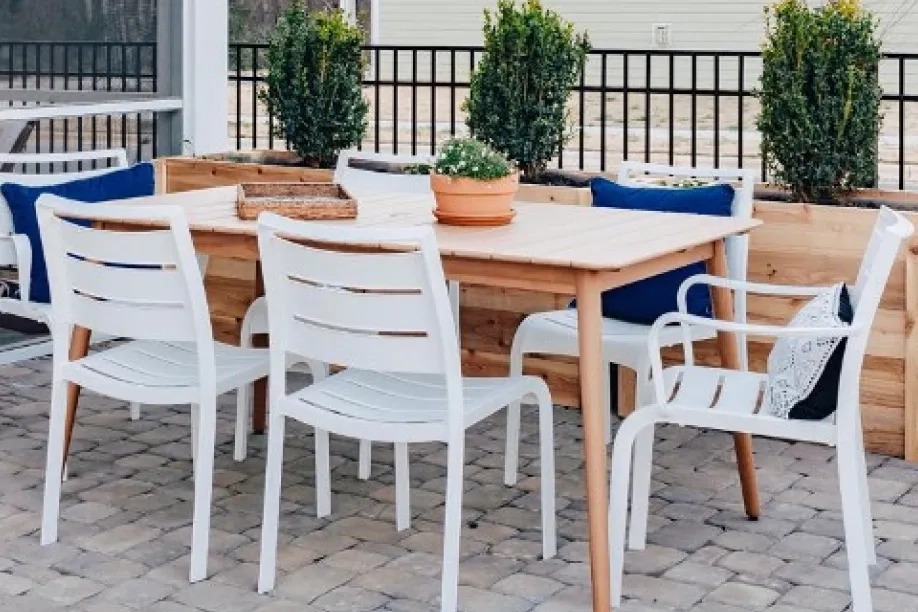 brown wood table with white chairs