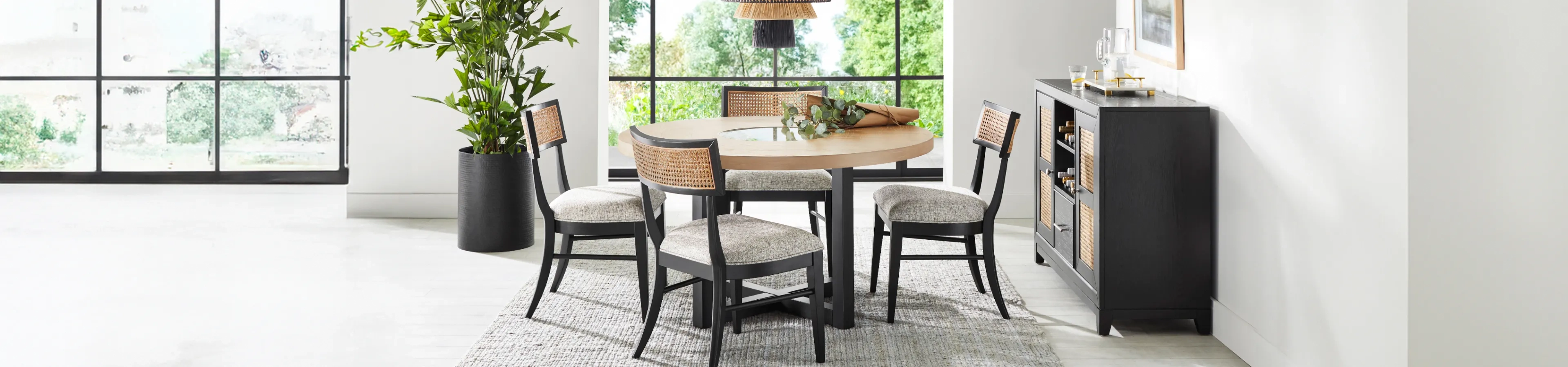 dining room with black chairs and brown and black table 