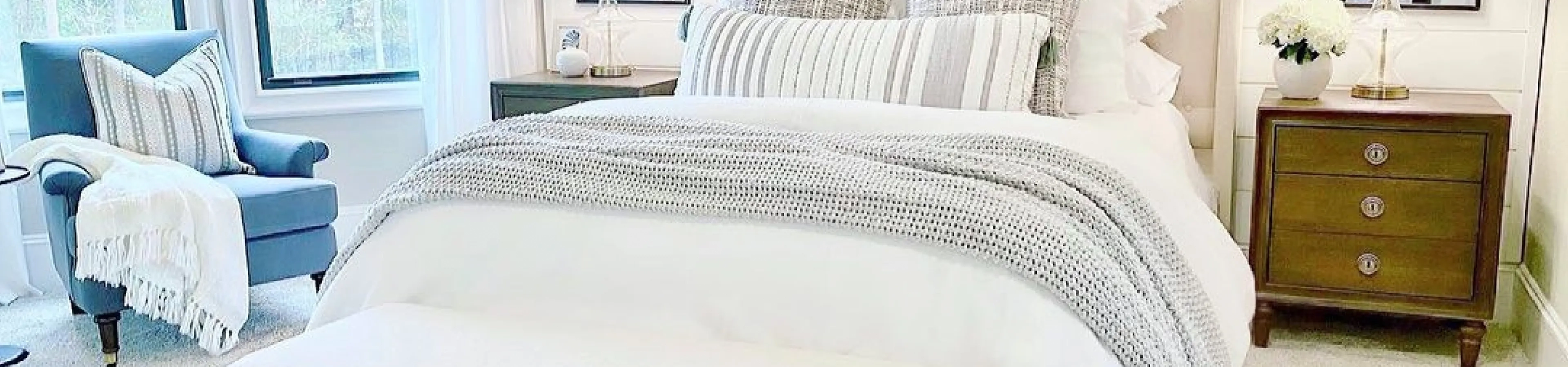 white bedspread and brown dresser