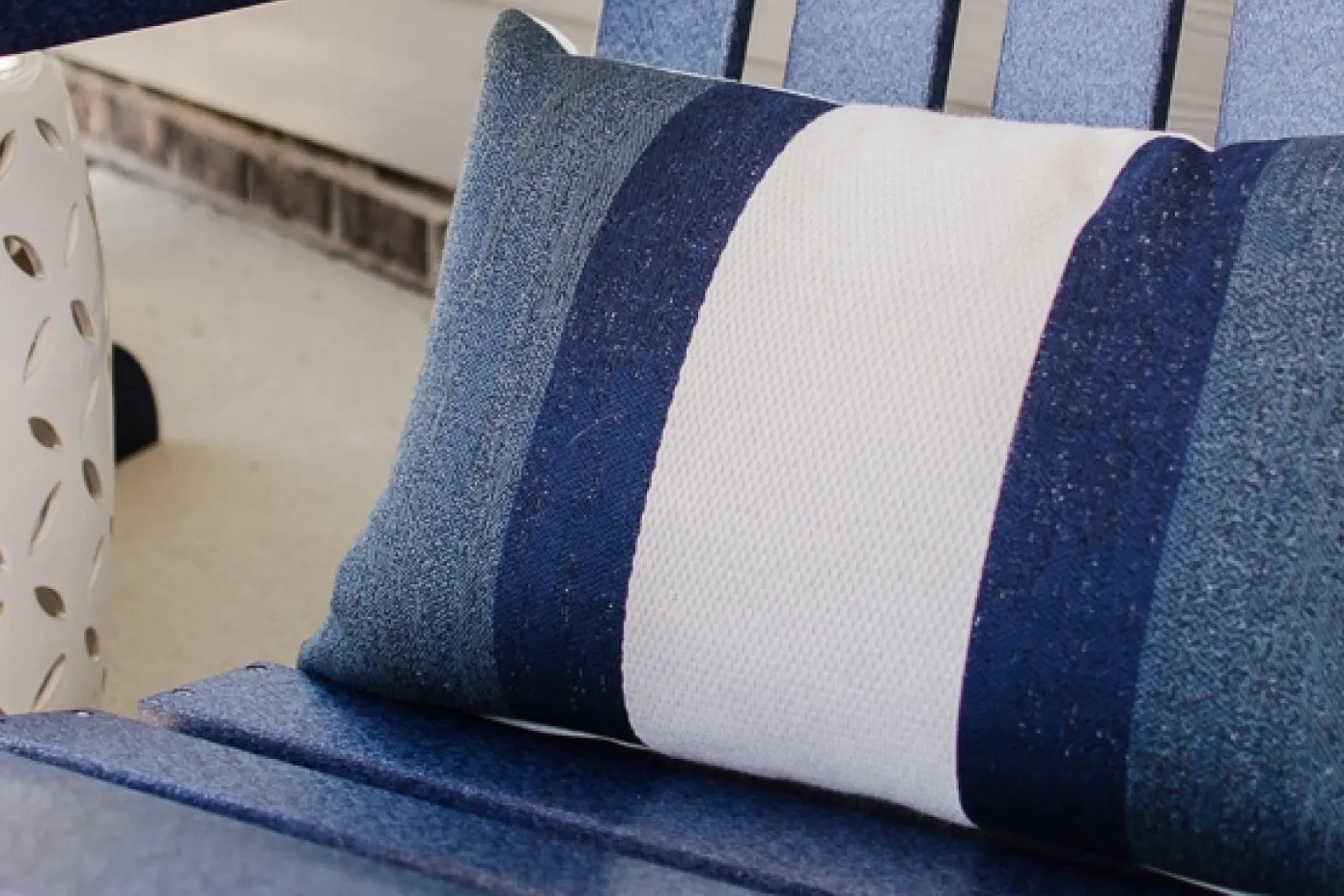 blue and white pillow on a blue chair 