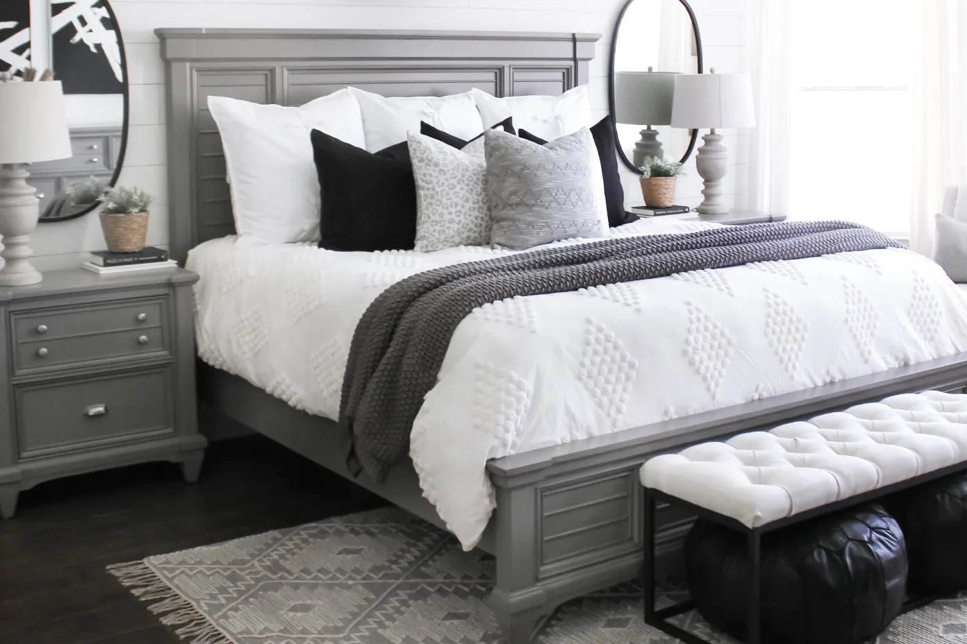 gray bedroom with white bench