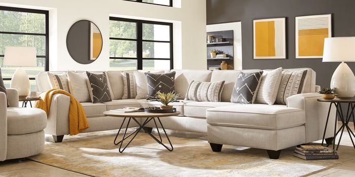 beige sectional set with decorative mirror and rug