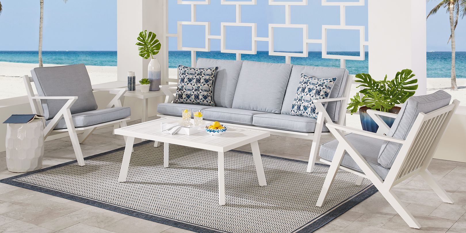 White patio seating set with blue cushions