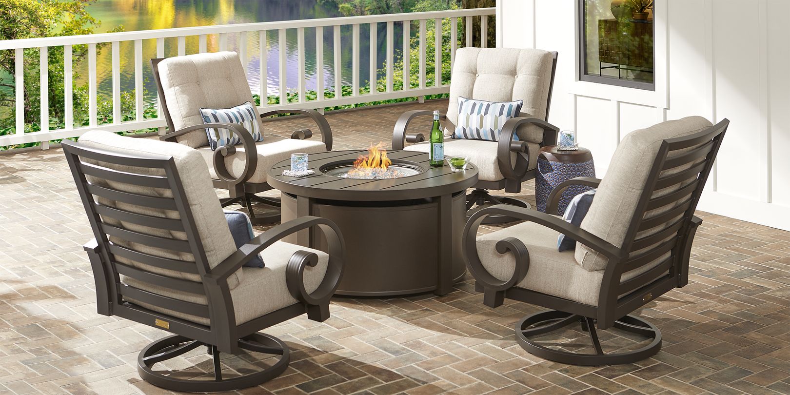 Photo of four bronze patio chairs and a fire pit table