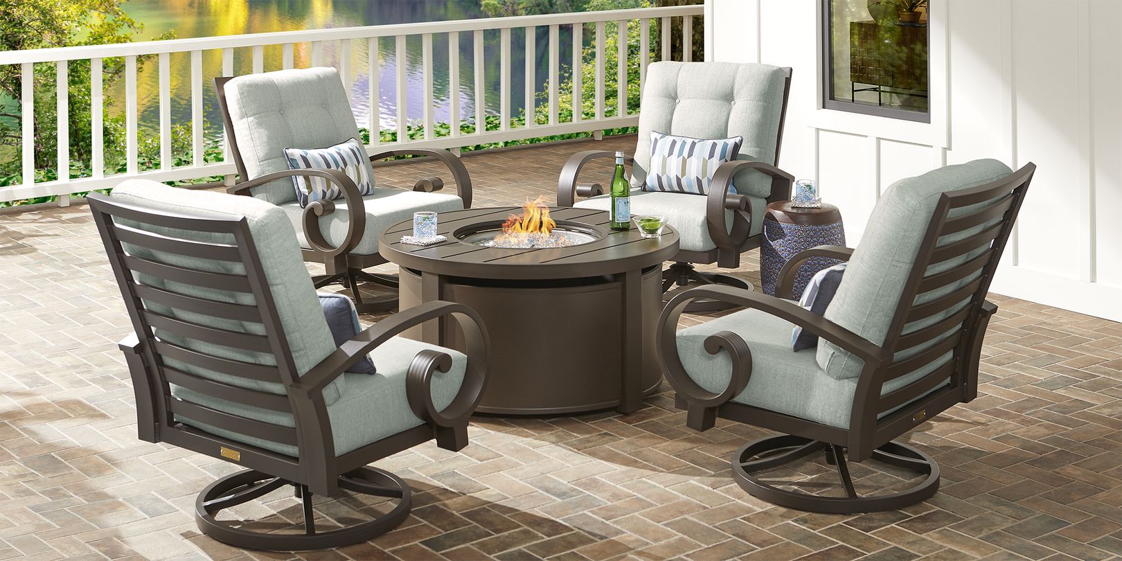 Photo of four bronze patio chairs and metal fire pit table