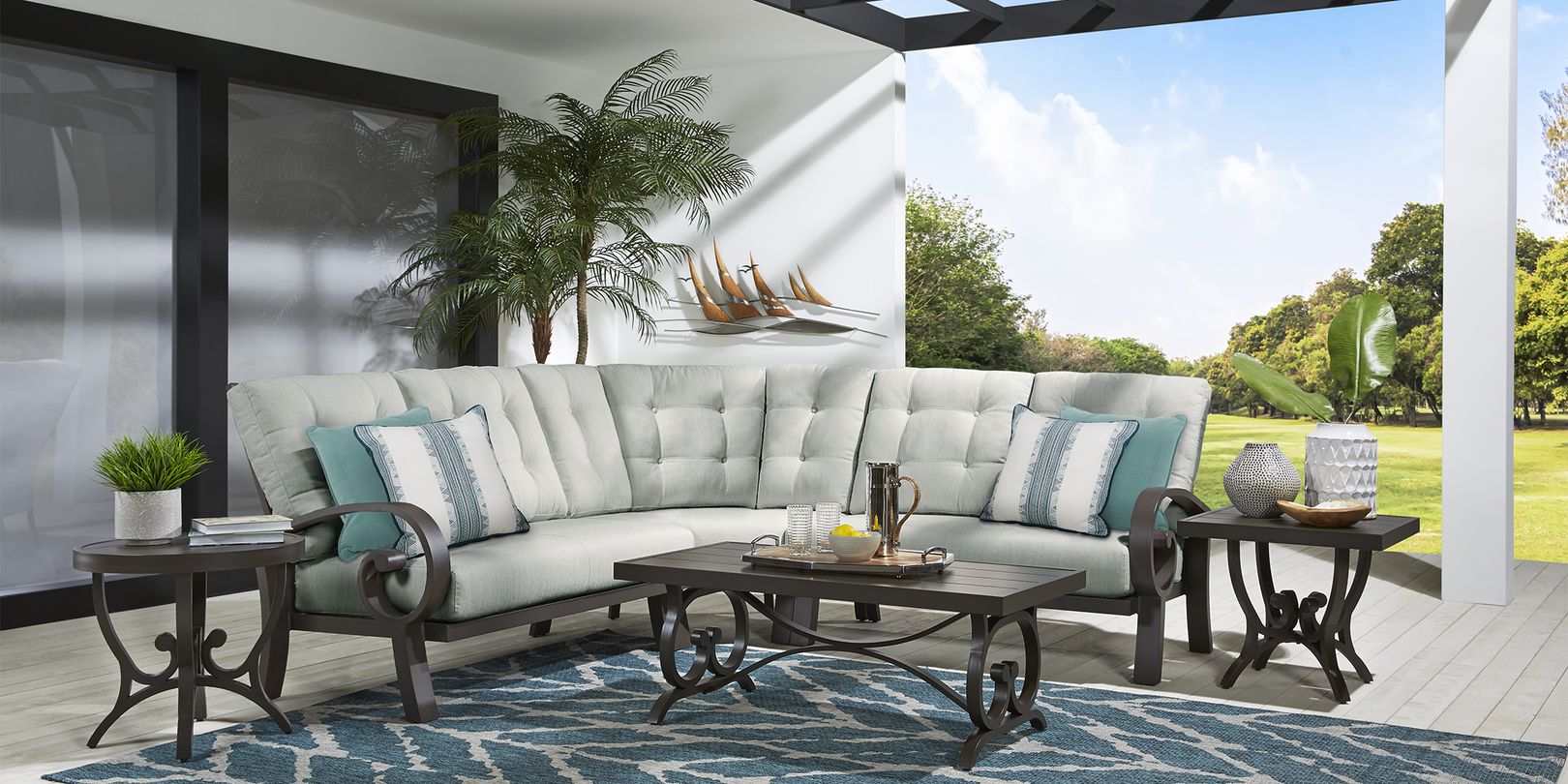 Photo of metal patio sectional with seafoam green cushions