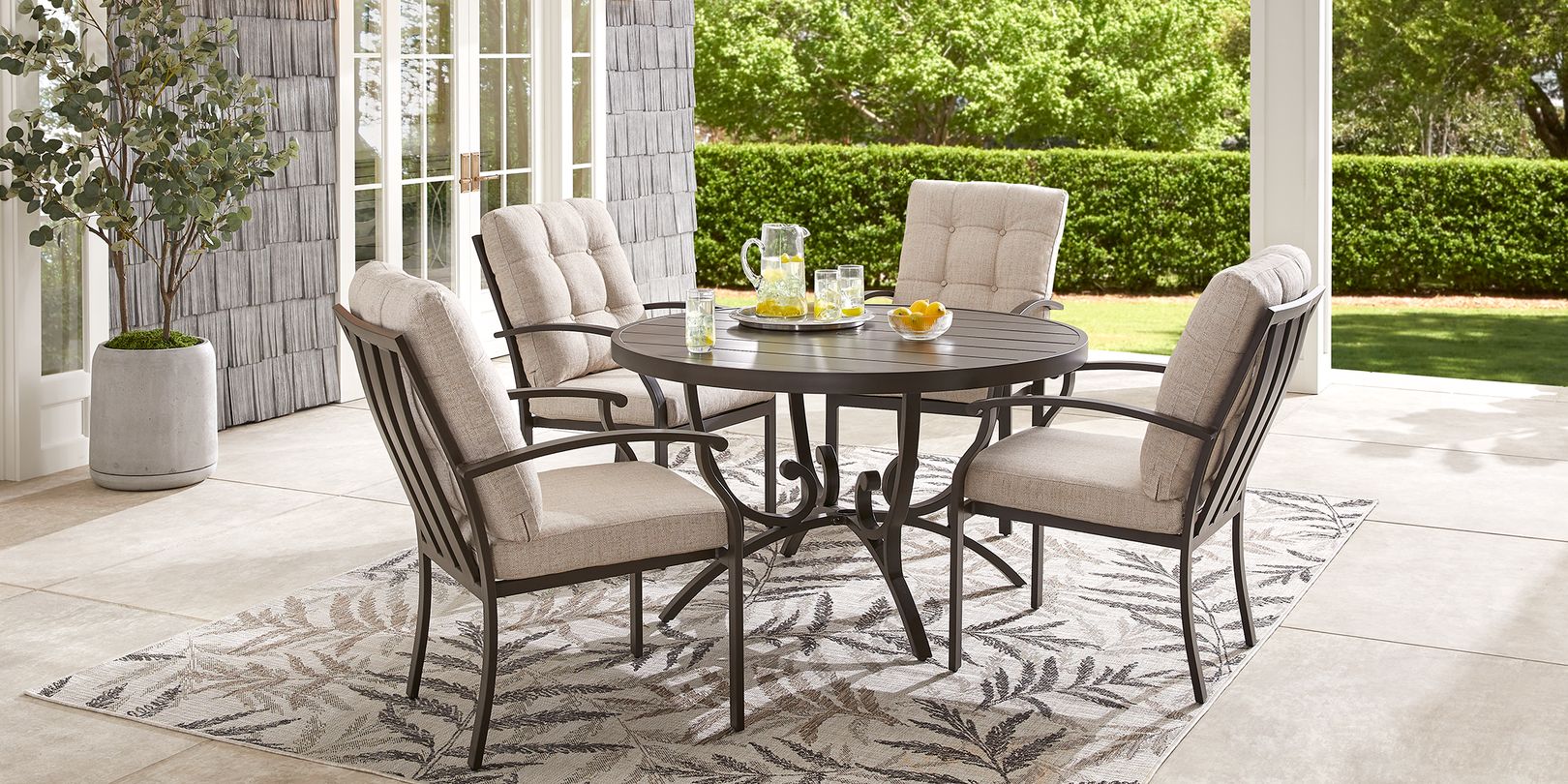 Photo of Brown Outdoor Dining Set with Thick Beige Cushions