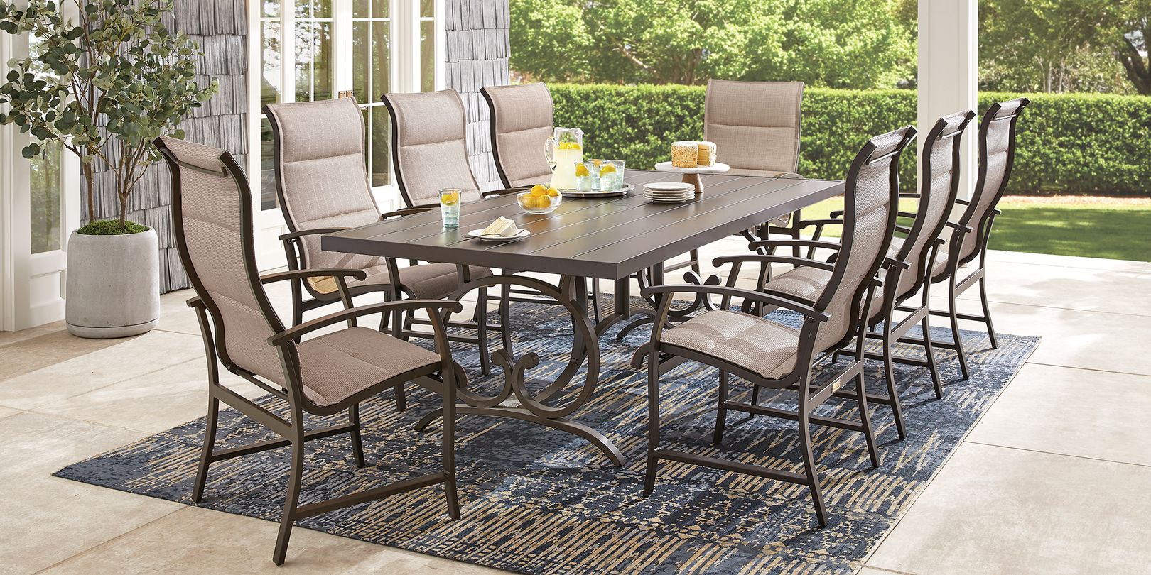 Photo of brown metal 9-piece outdoor dining set