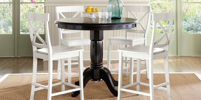 white dining chairs around black table