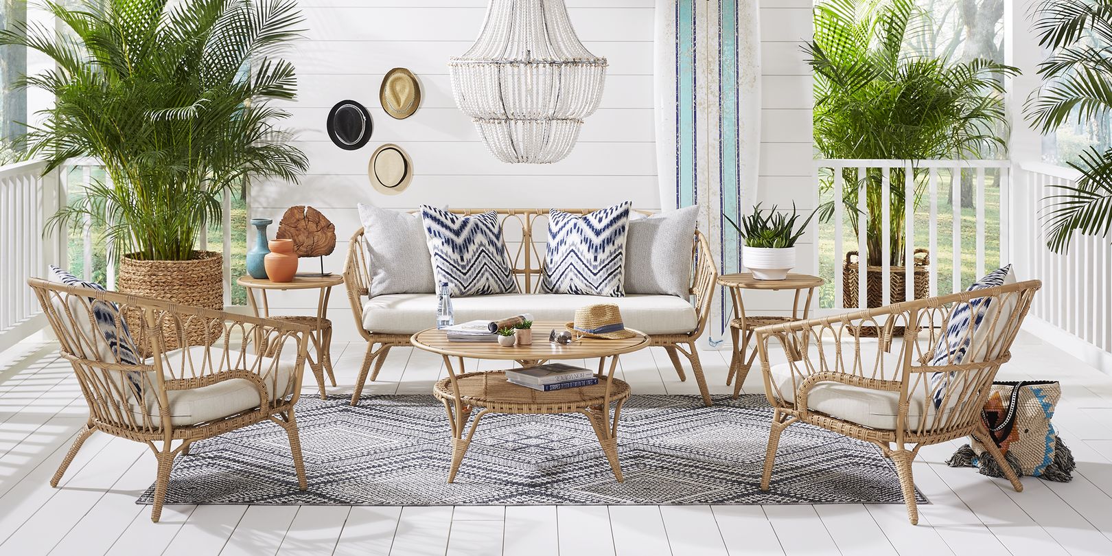 photo of a rattan outdoor loveseat and chairs with coordinating coffee and end tables