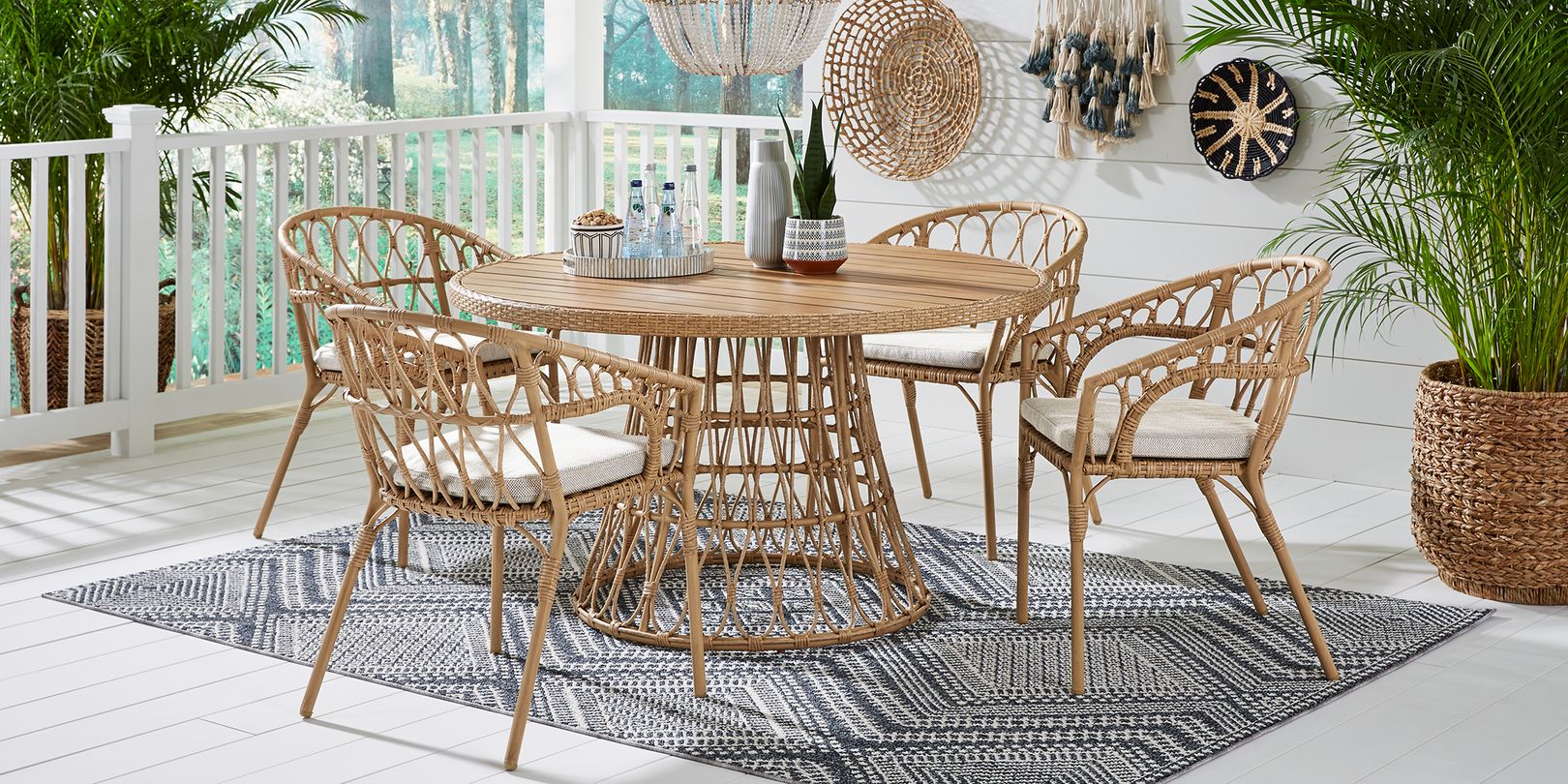 Photo of a round rattan outdoor dining table and chairs