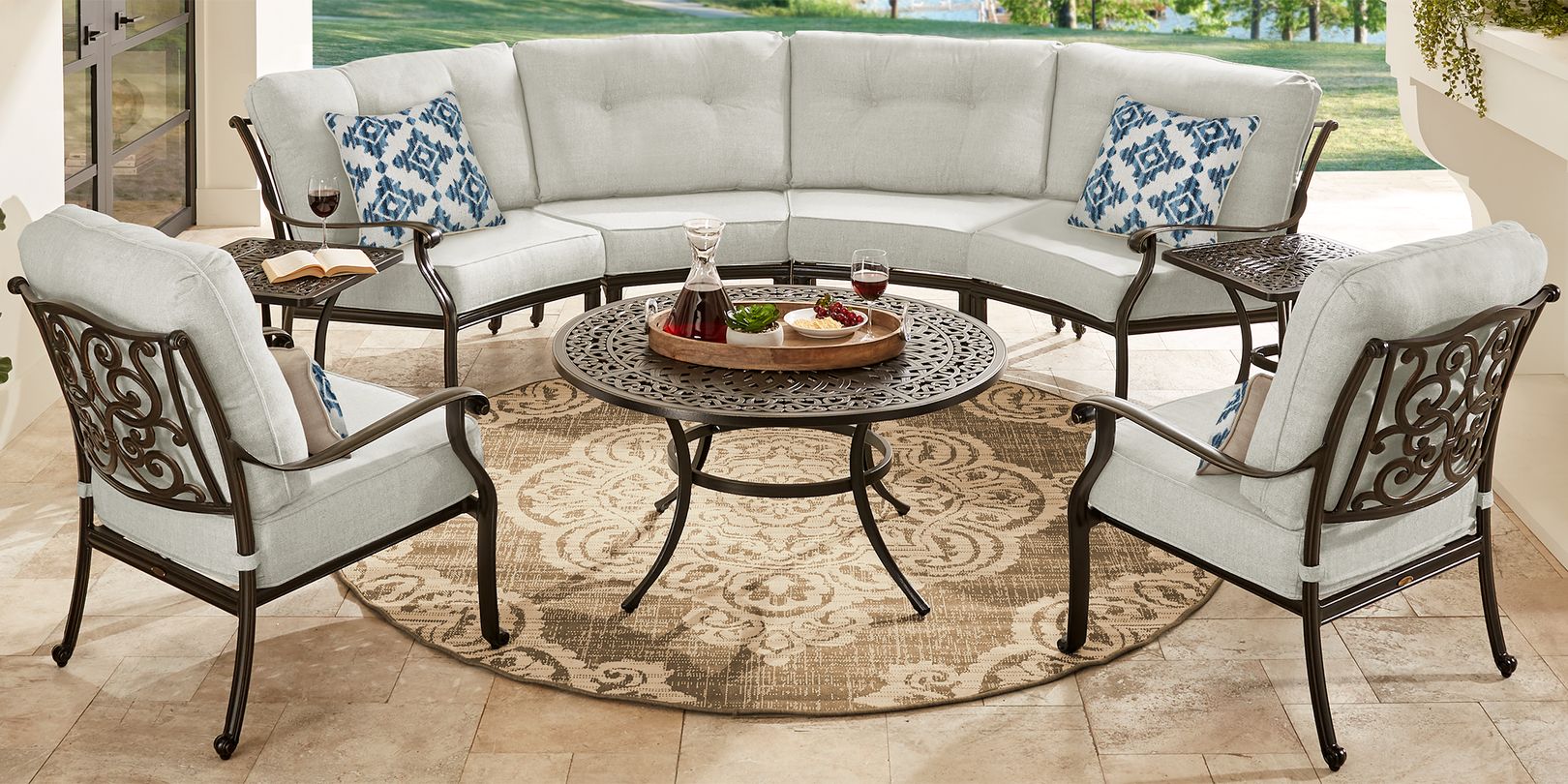 Photo of outdoor sectional with gray cushions set atop a beige rug