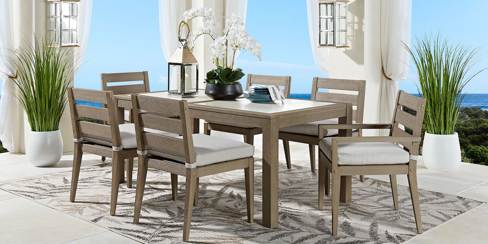 photo of gray dining set with plants