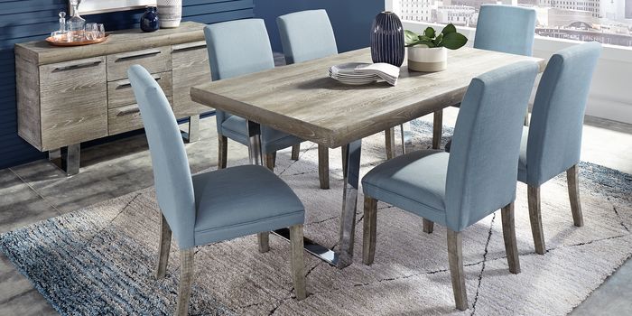 blue dining chairs around light gray wood table