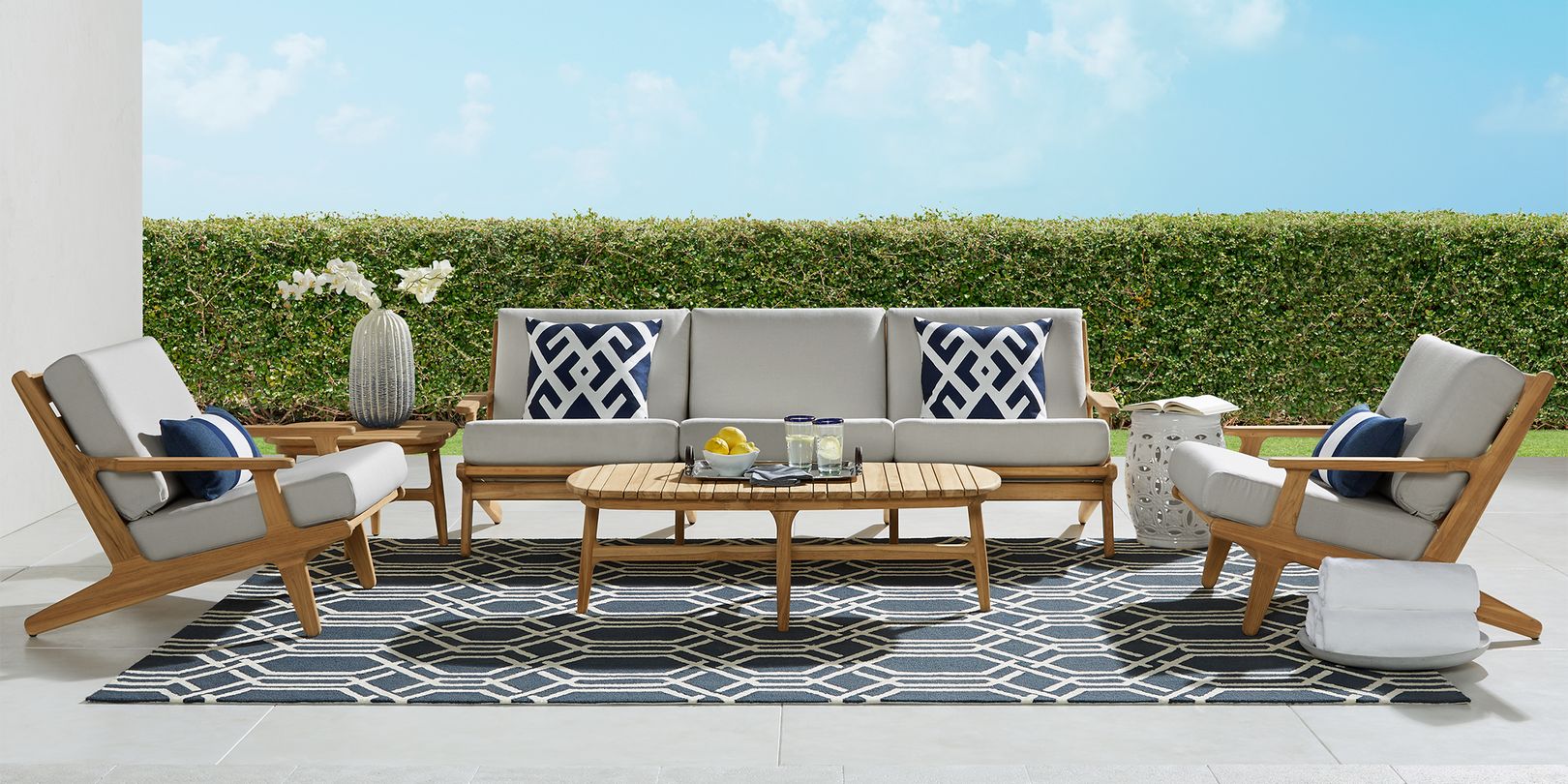 photo of teak patio seating set with gray cushion