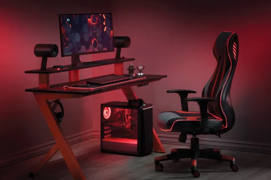 red desk with chair and computer