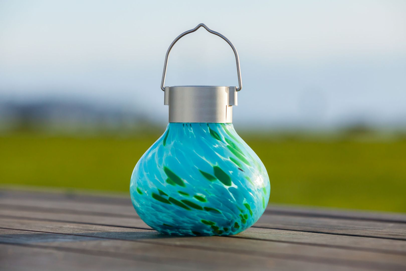 Photo of green and teal swirled outdoor solar lantern