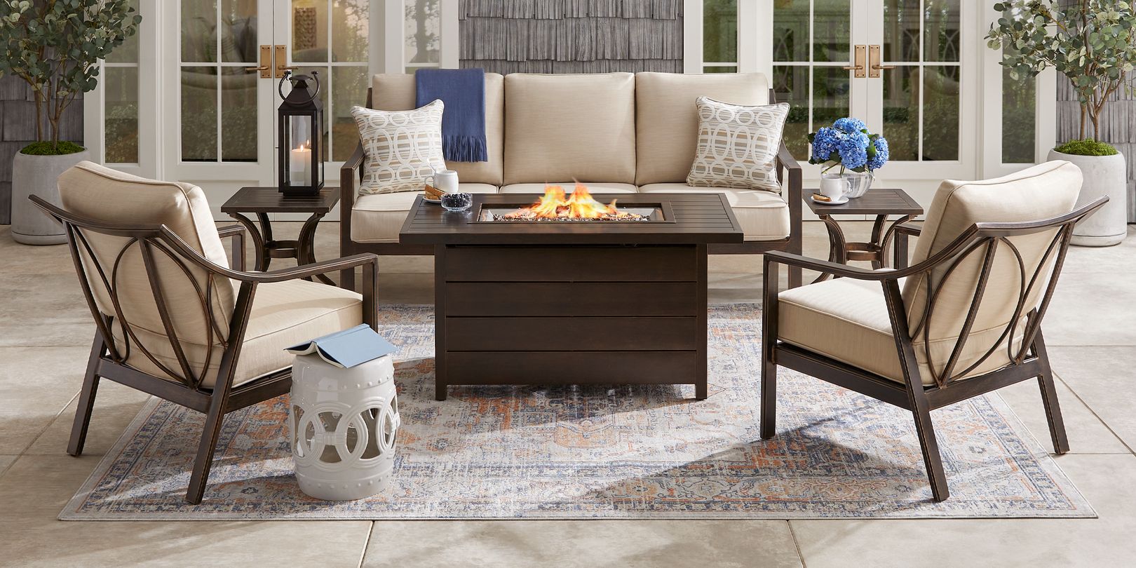 Photo of brown metal outdoor seating set and brown fire pit