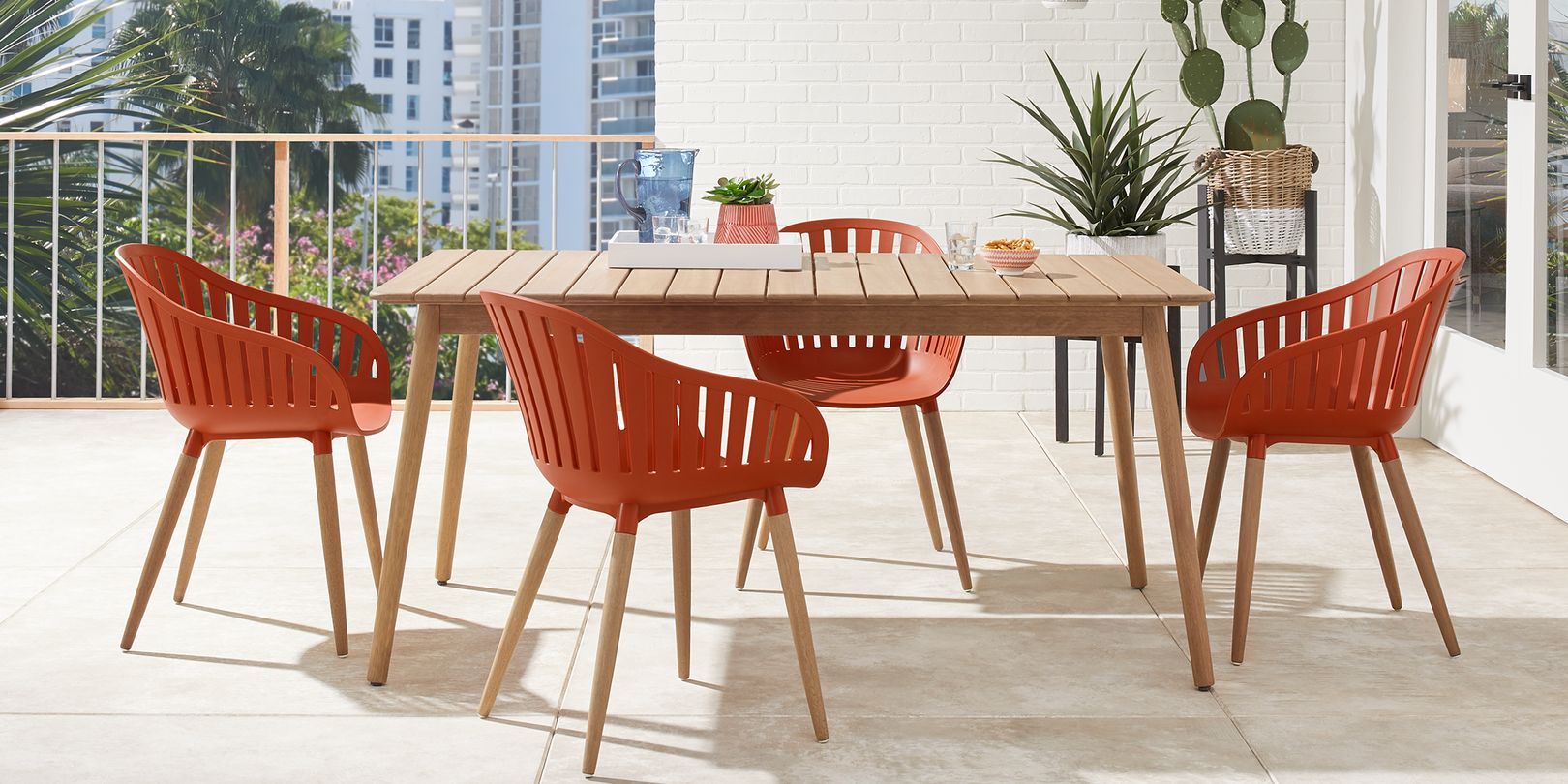 Photo of wooden mid-century modern patio dining set with orange chairs