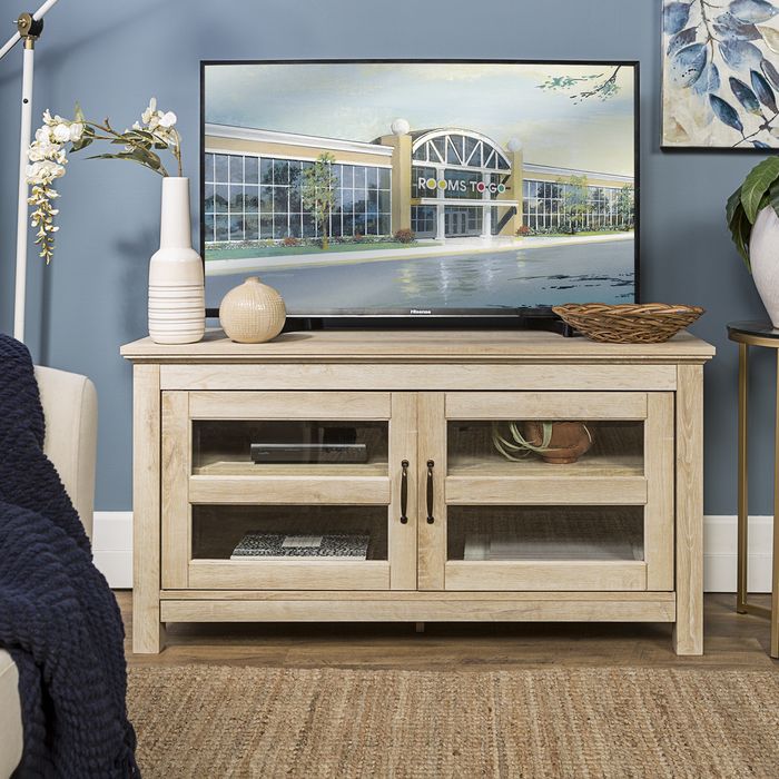 white tv console with brown and tan decor accents
