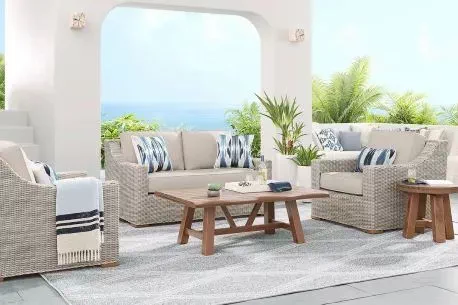 white wicker patio loveseat with white cushions 