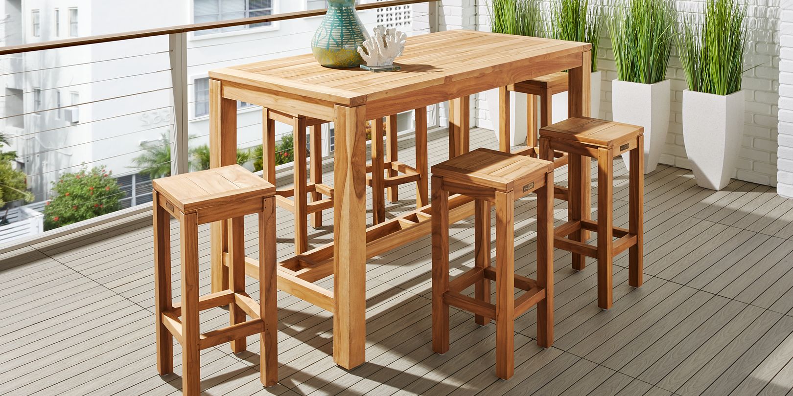Photo of teak bar height dining table with stools