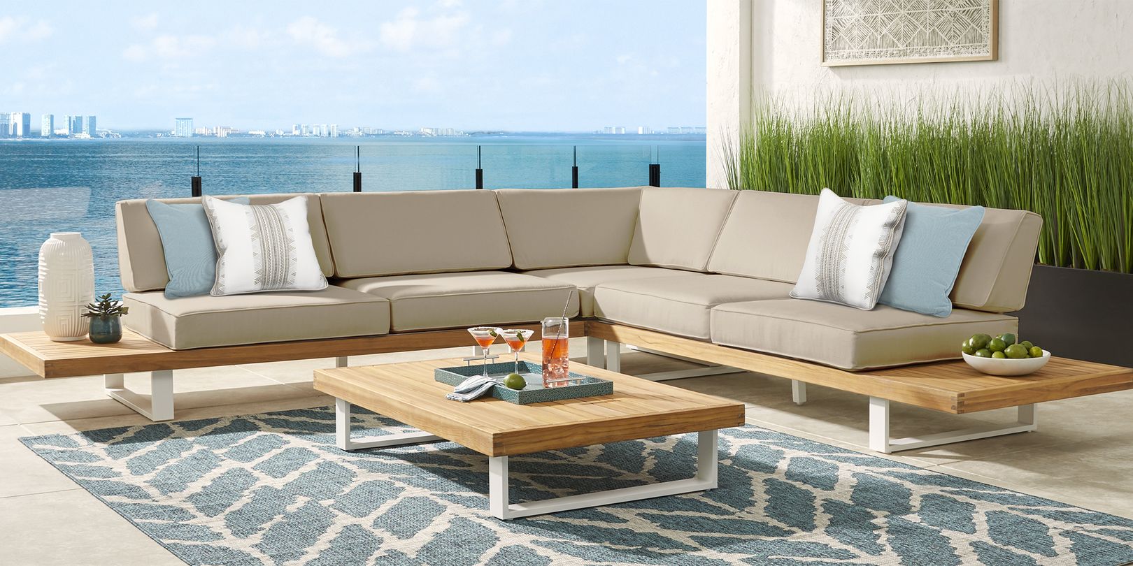 photo of teak three piece patio sectional with gray cushions
