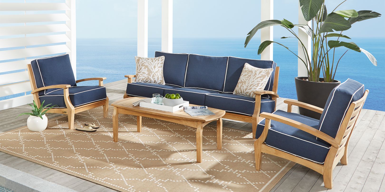 Photo of teak patio seating set with navy and denim cushions