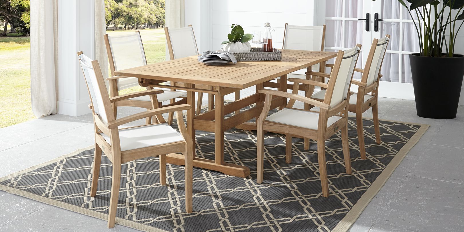 Photo of teak dining set with chairs