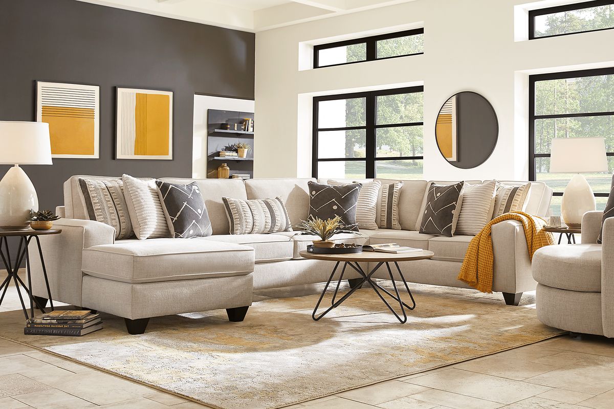 Beige 3 seater sectional couch with green and gray accent pillows