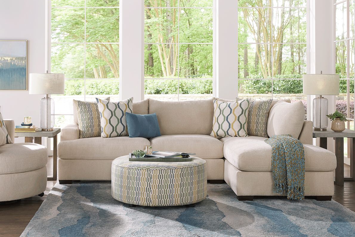 Beige 3 seater sectional couch with green and gray accent pillows