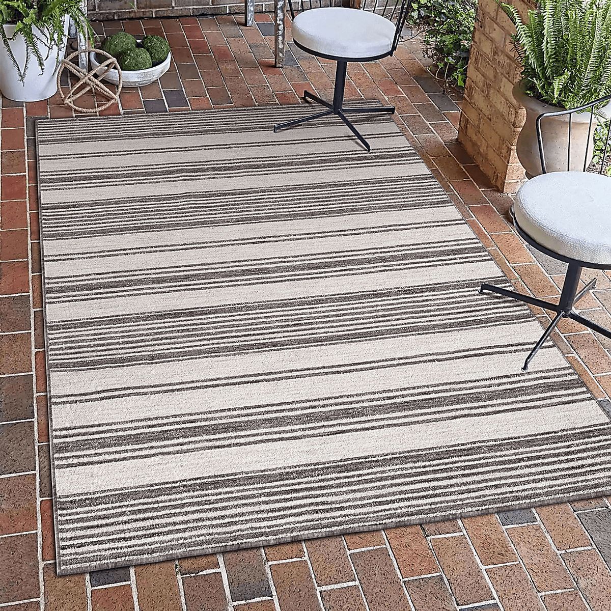 Caradley Ivory Beige Outdoor Rugs | Rooms to Go