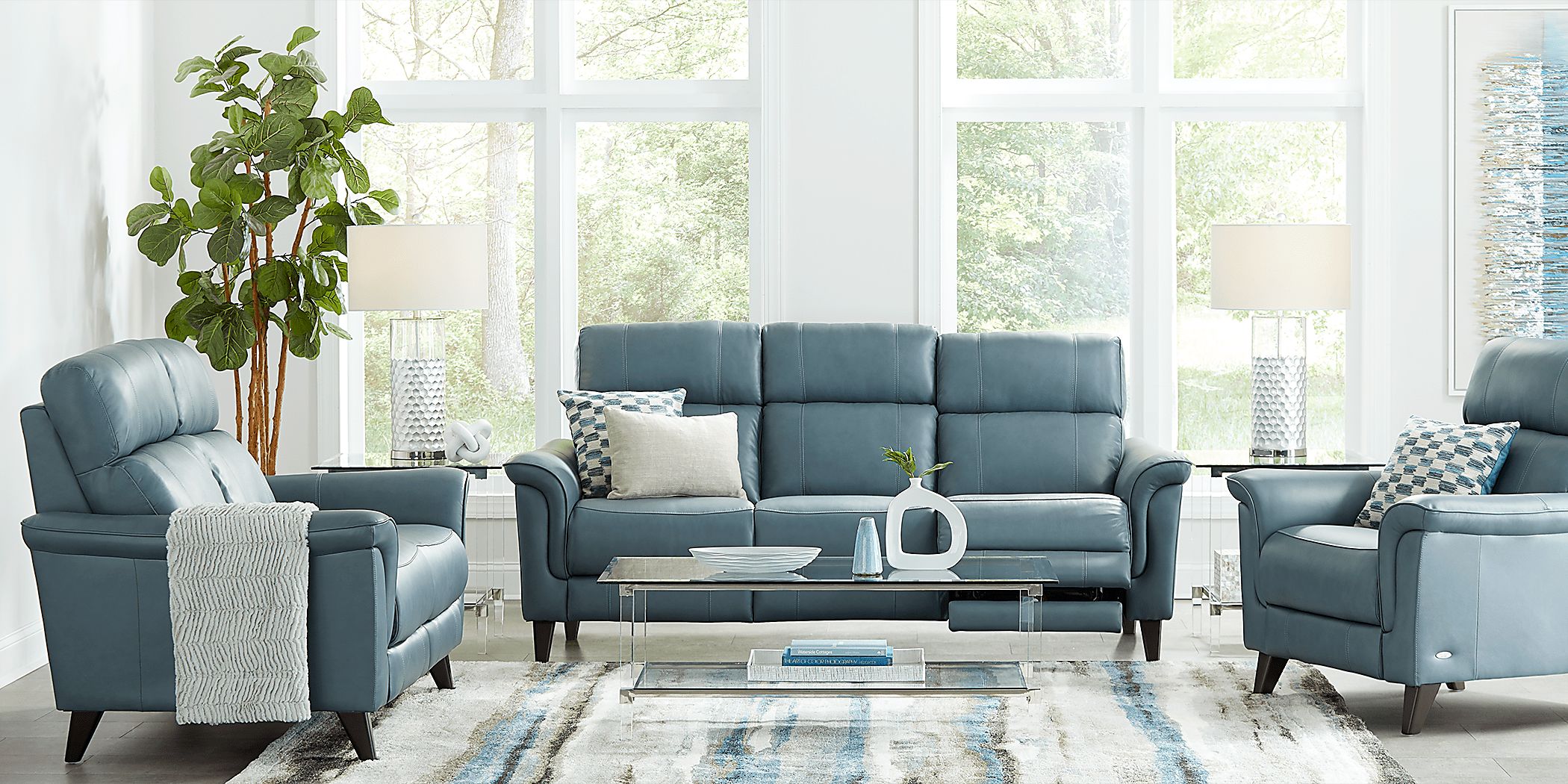 https://assets.roomstogo.com/product/cindy-crawford-home-avezzano-blue-2-pc-leather-living-room-with-dual-power-reclining-sofa_1007109P_image-room?cache-id=29991ab2a722e7661013d057ee3e4b3c