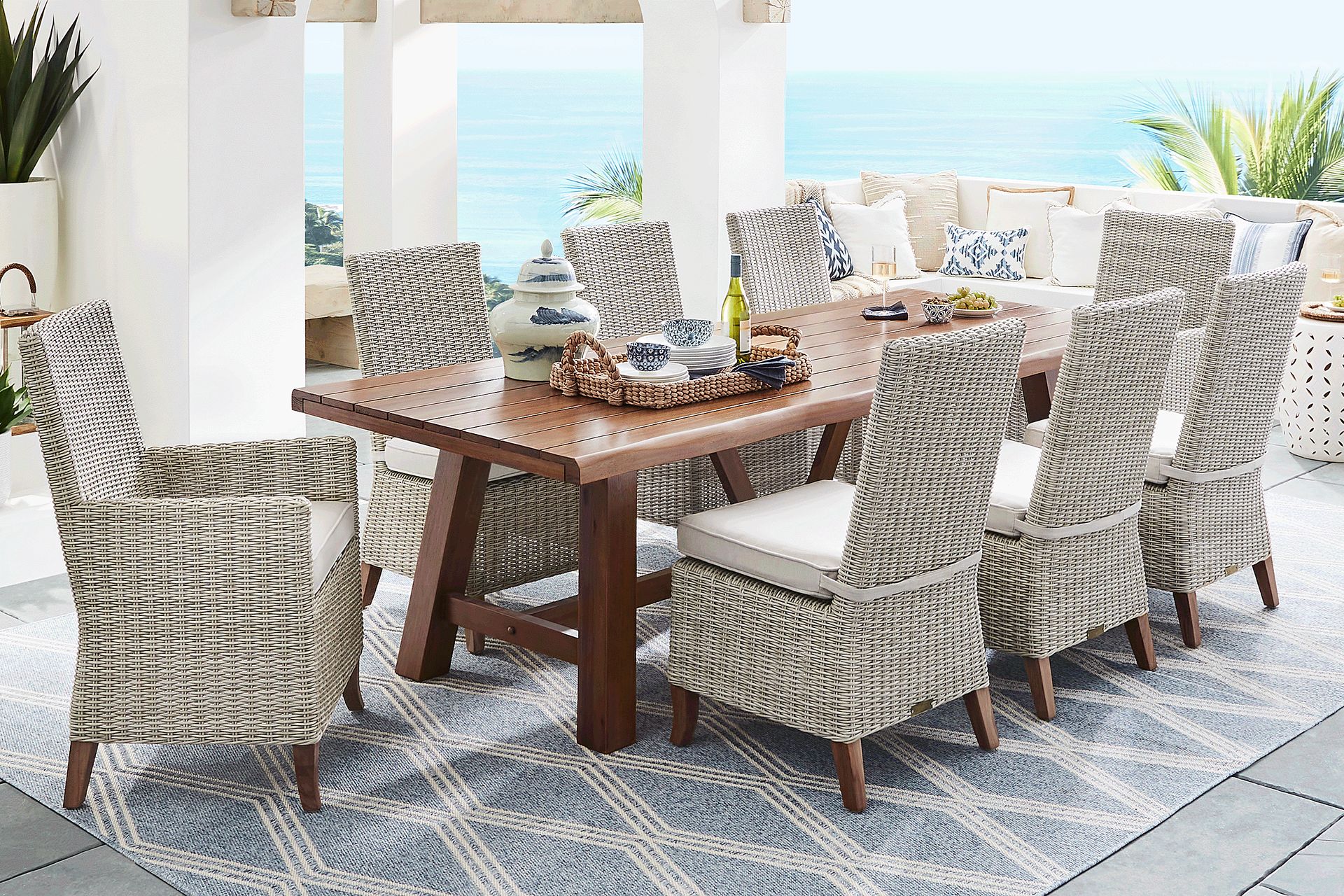 Patmos Tan 7 Pc 102 in. Rectangle Outdoor Dining Set With Linen Cushions - Image 1