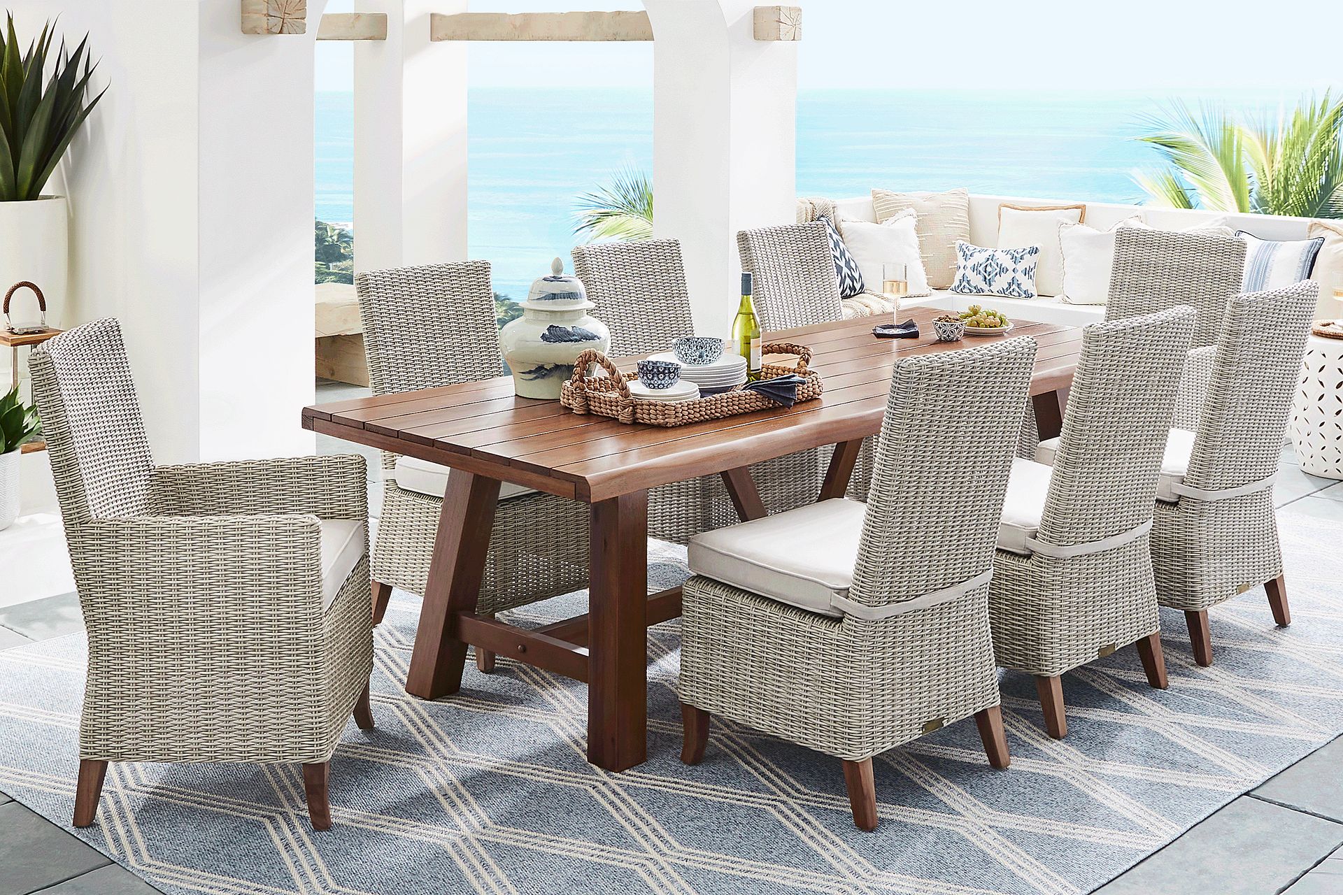 Patmos Tan 9 Pc 102 in. Rectangle Outdoor Dining Set With Linen Cushions - Image 1