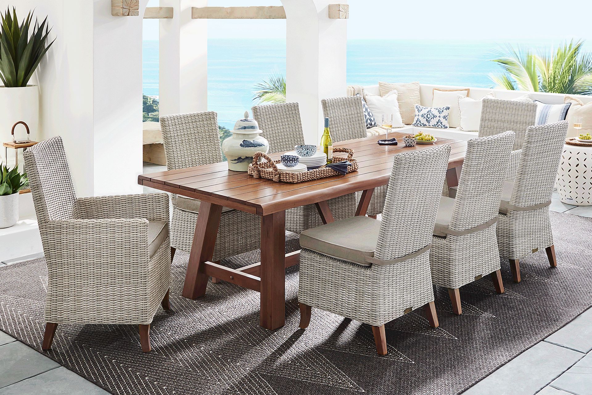 Patmos Tan 9 Pc 102 in. Rectangle Outdoor Dining Set With Mushroom Cushions - Image 1