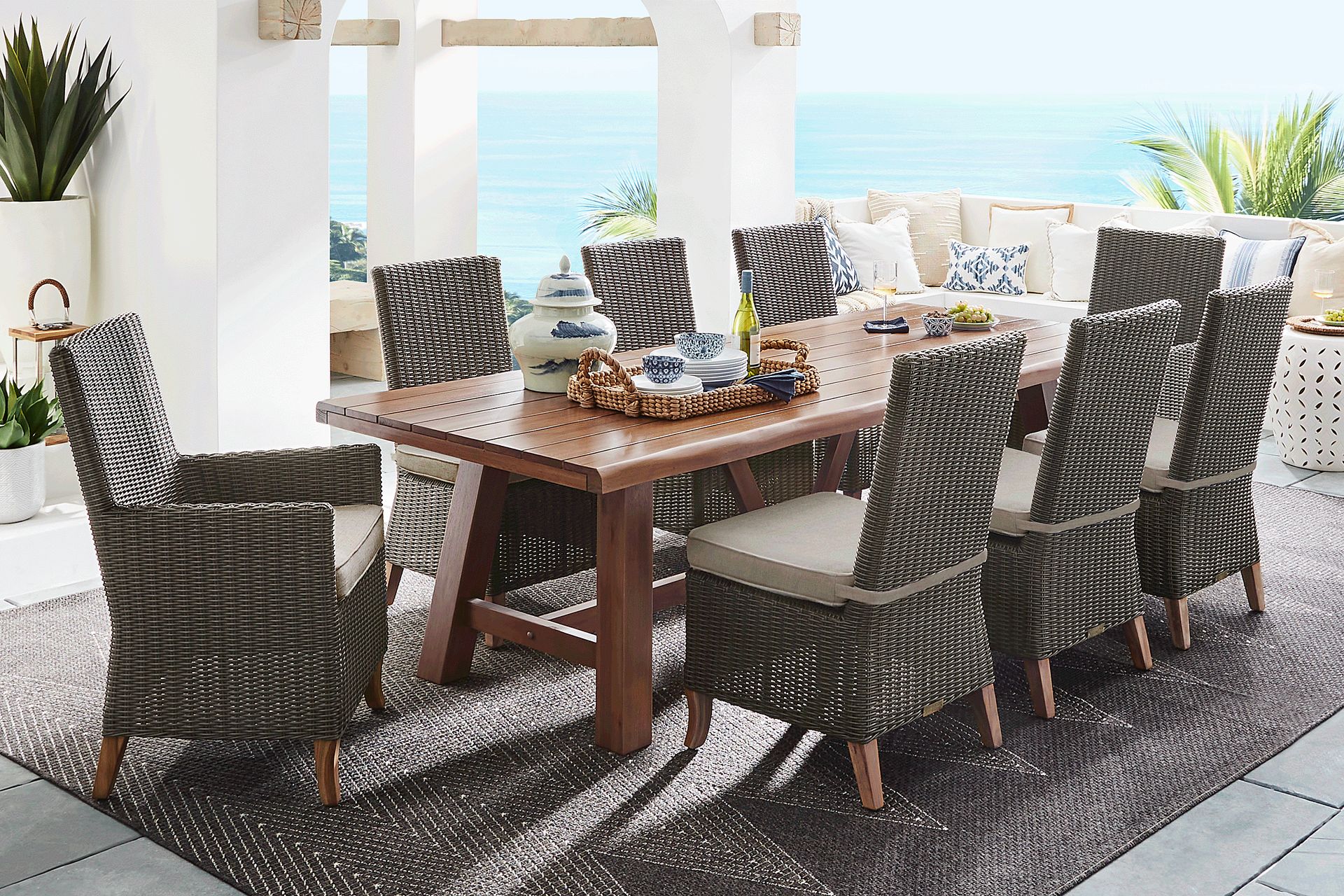 Patmos Tan 9 Pc 102 in. Rectangle Outdoor Dining Set With Mushroom Cushions - Image 1
