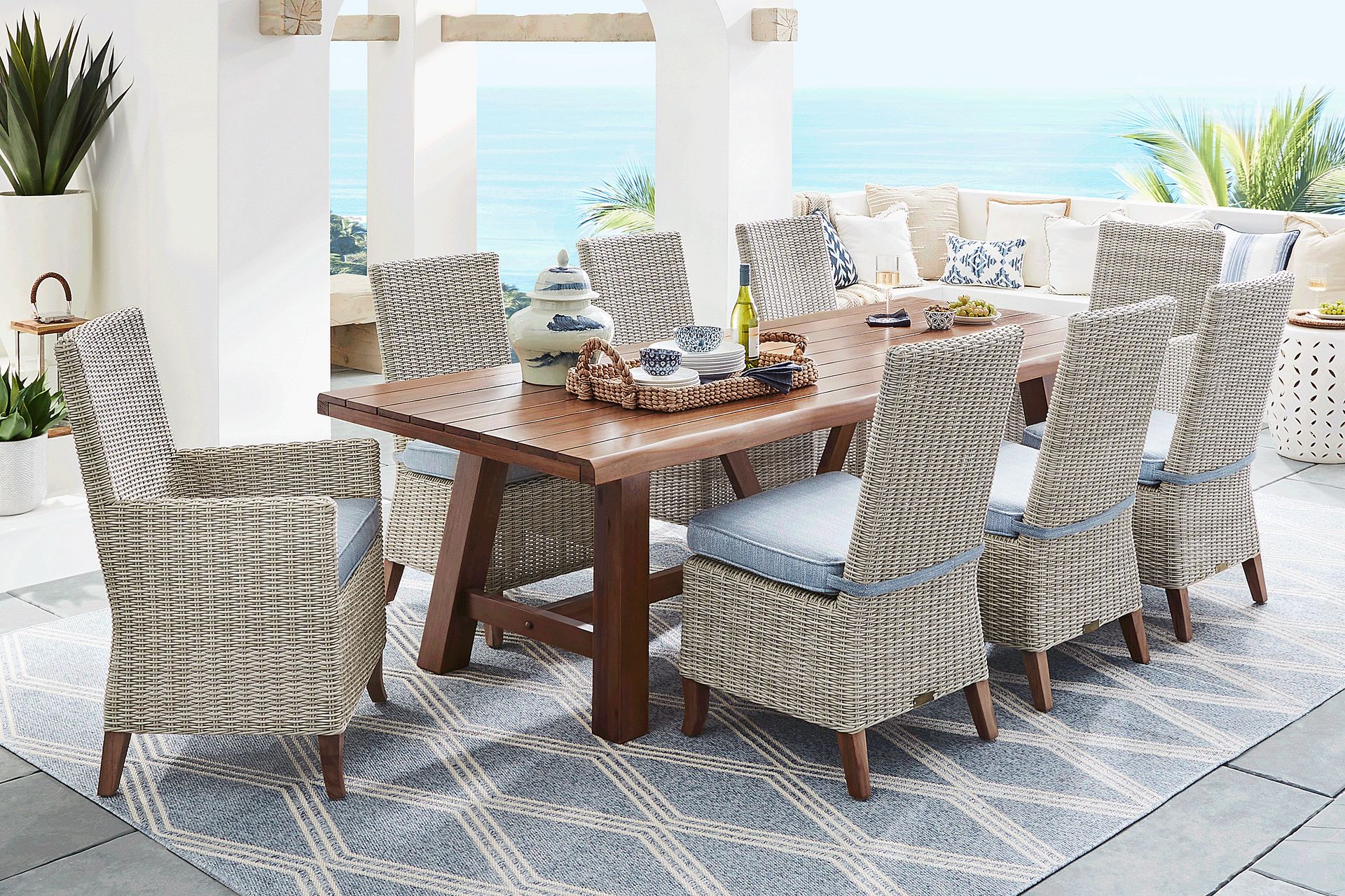 Patmos Tan 9 Pc 102 in. Rectangle Outdoor Dining Set With Steel Cushions - Image 1