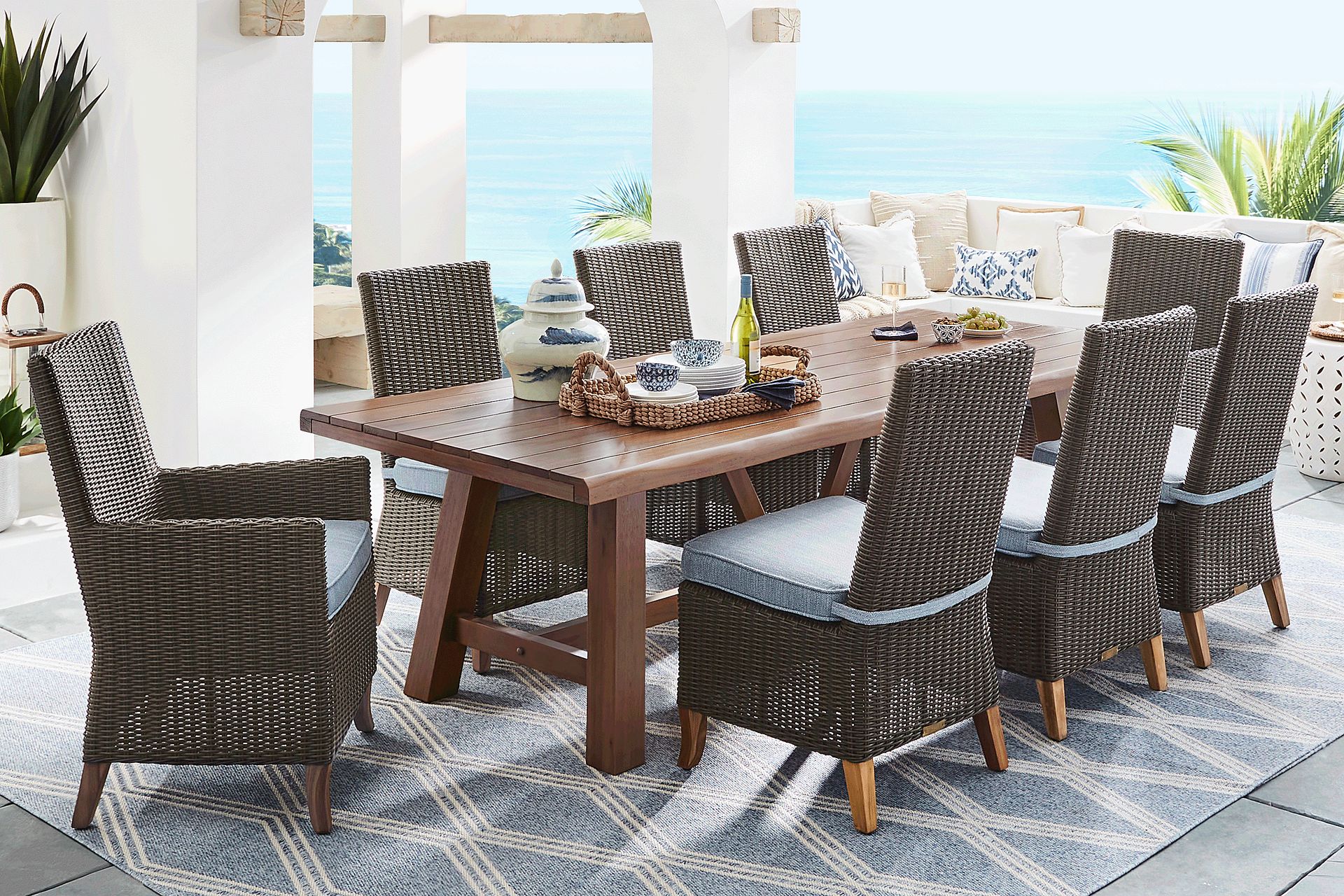 Patmos Tan 9 Pc 102 in. Rectangle Outdoor Dining Set With Steel Cushions - Image 1