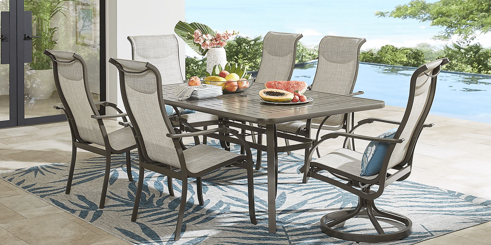 Windy Isle Bronze 7 Pc 72 in. Rectangle Outdoor Dining Set with Swivel Rockers - Image 1
