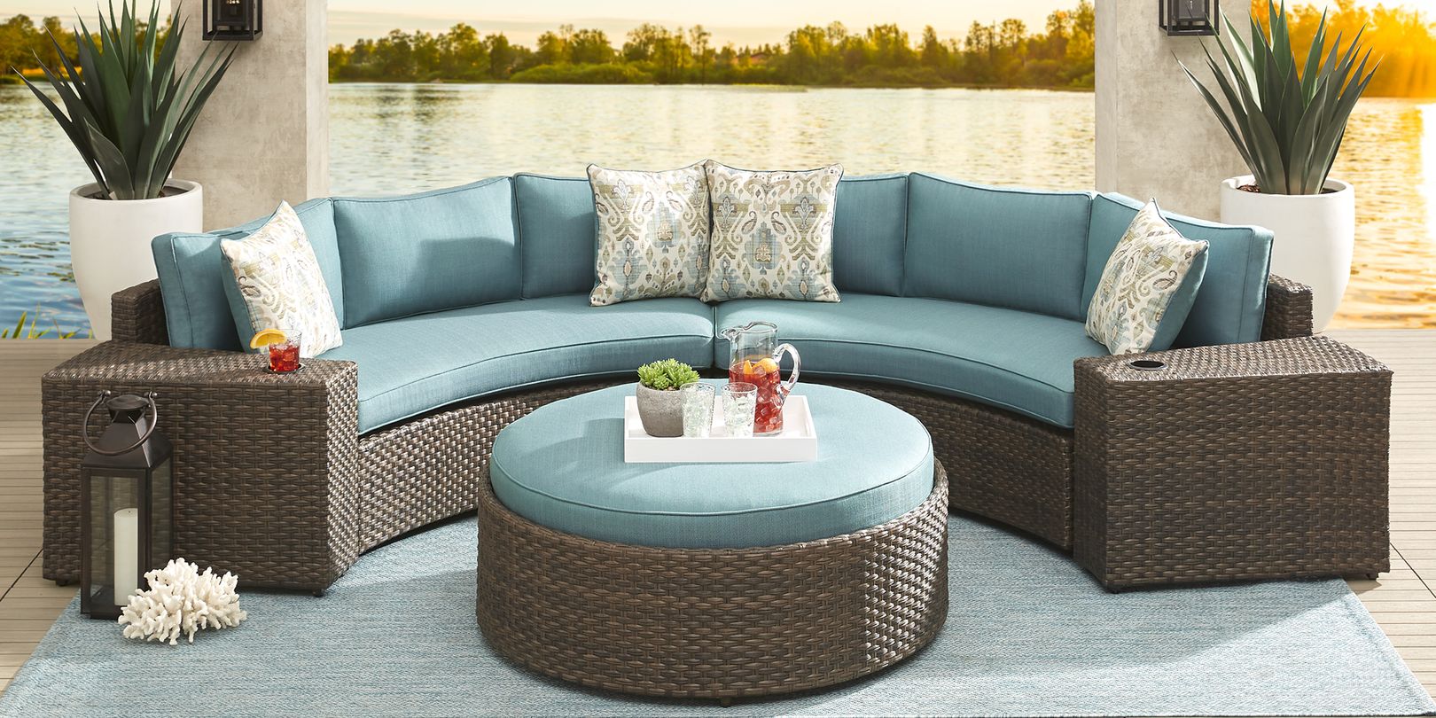 photo of a curved brown wicker sectional with aqua blue cushions