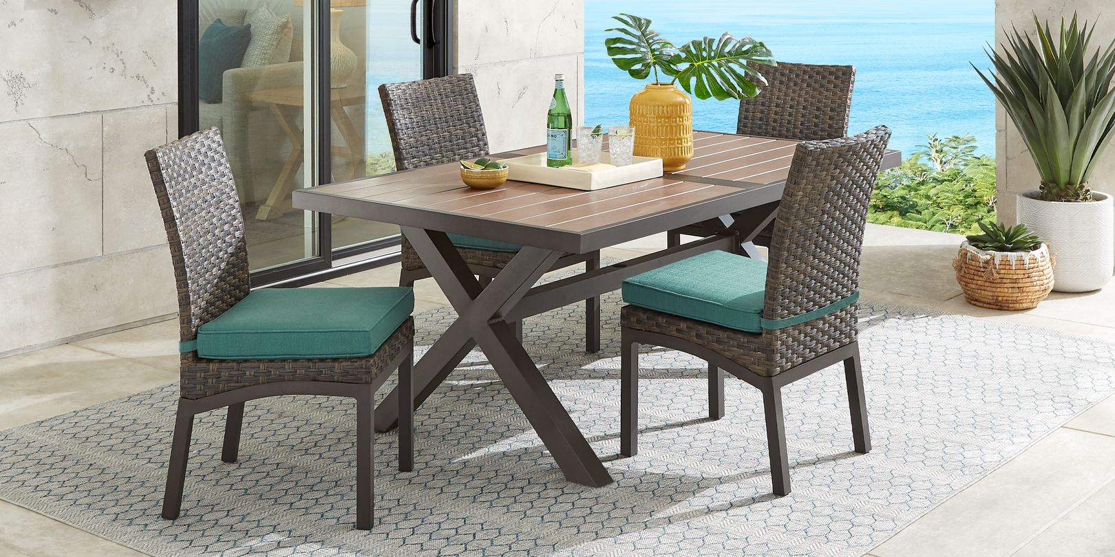 Photo of brown patio dining set with plants on the table and in the background